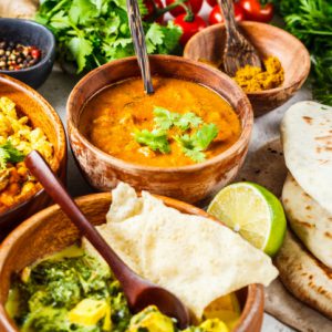 dal-palak-paneer-curry-rice-chapati-chutney-wooden-bowls-white-table_79830-1748